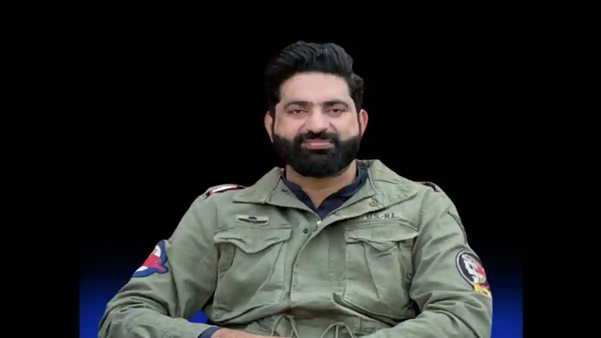 Nasir Dhillon in green army-style jacket.