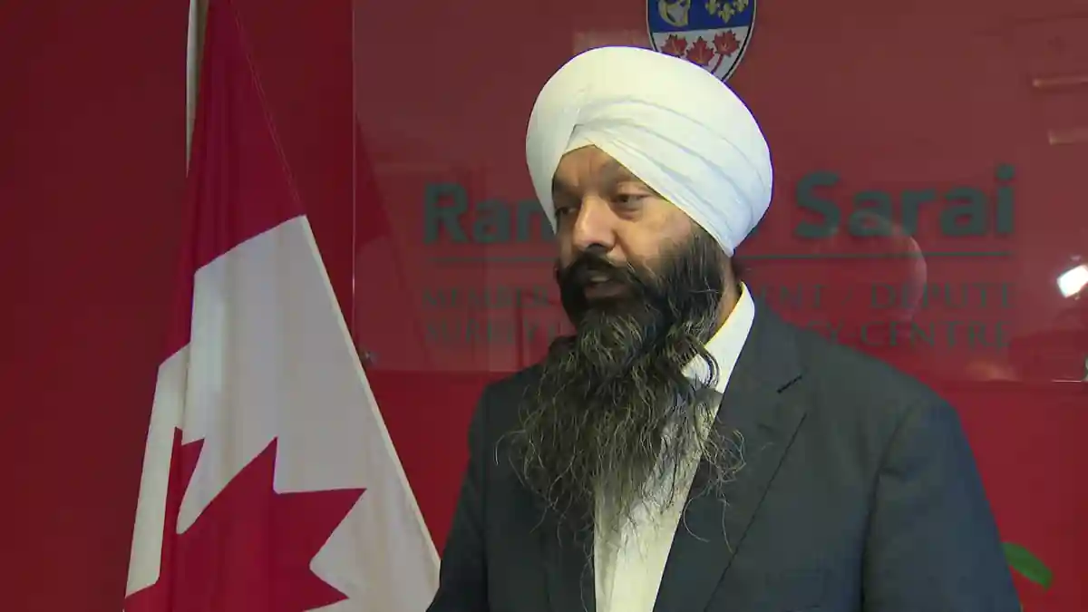Randeep Sarai, Member of Parliament from Surrey-Centre, standing with Canadian flag background