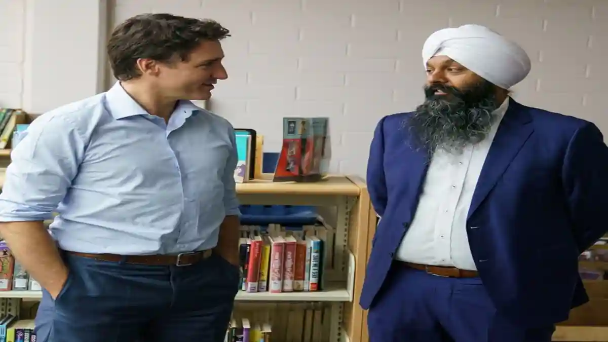 Randeep Sarai with Trudeau at political event.