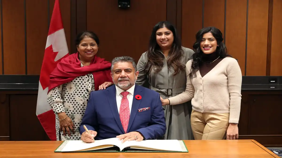 Sukh Dhaliwal with his family after signing – ਕੈਨੇਡਾ ਦੇ Member of Parliament Sukh Dhaliwal apni family ਦੇ ਨਾਲ historic moment capture ਕਰਦੇ ਹੋਏ।